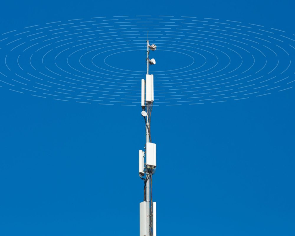 Telecommunication cell tower antenna against blue sky background. Wireless communication and modern mobile internet. Radio emission